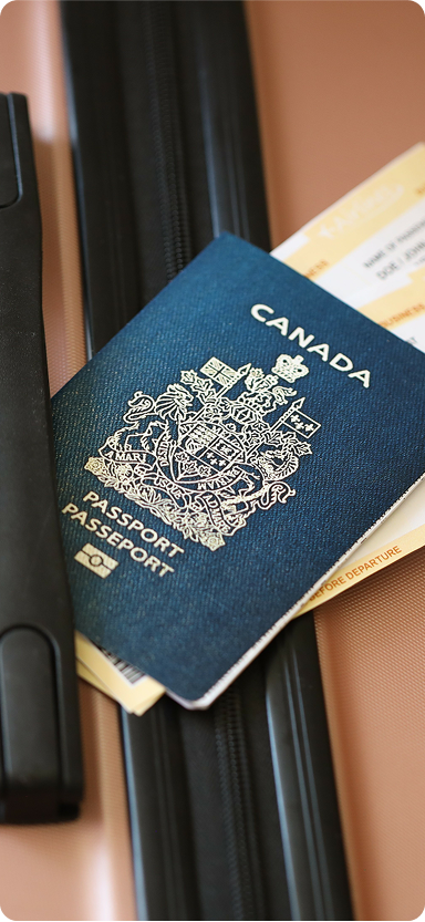 A photo of a Canadian passport with a ticket for a flight underneath it.