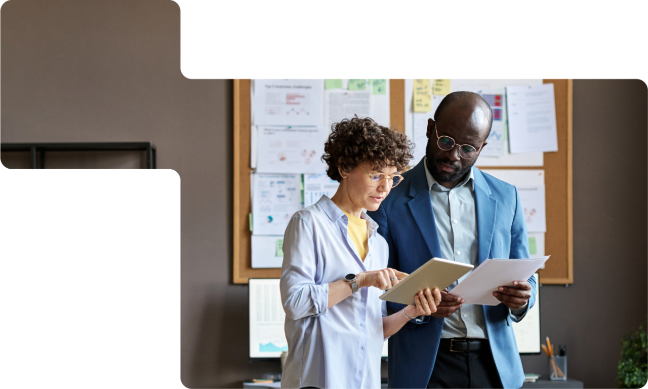 A woman and a man in an office setting reviewing paperwork